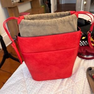 Bucket bag with addition cross body strap